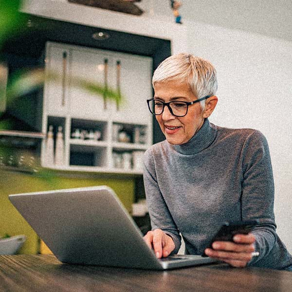 Woman smiling looking at her computer