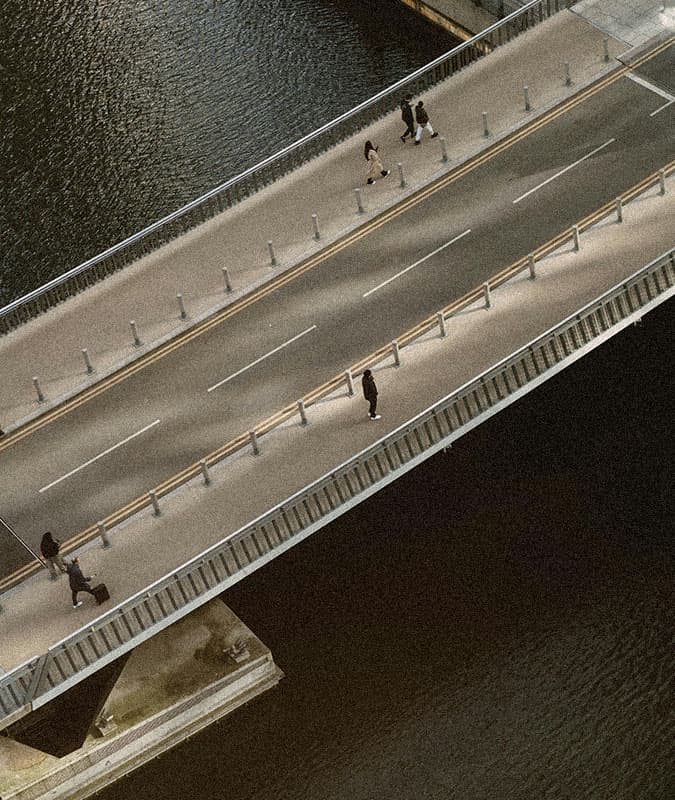 people walking across a bridge