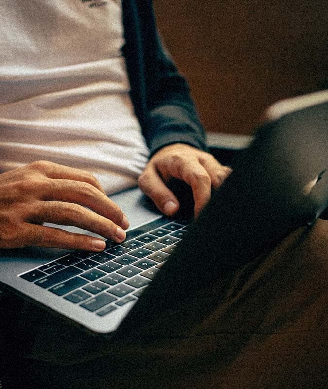 hands typing on laptop keyboard